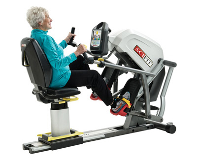 Woman using recumbent machine with standard chair